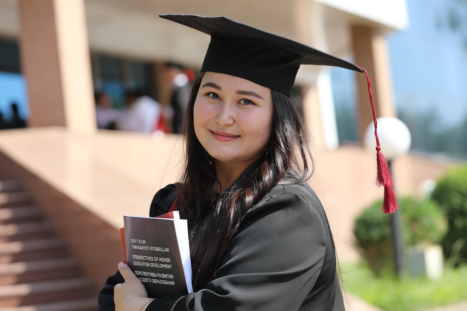 a woman in a graduation gown holding a book